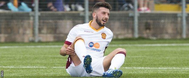 Motherwell's Lee Lucas lies injured against Annan Athletic