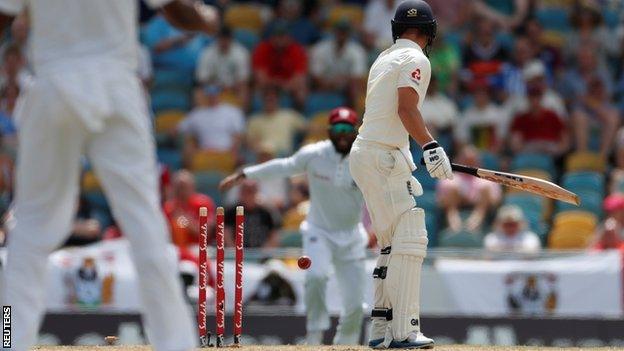 Rory Burns is bowled by Kemar Roach