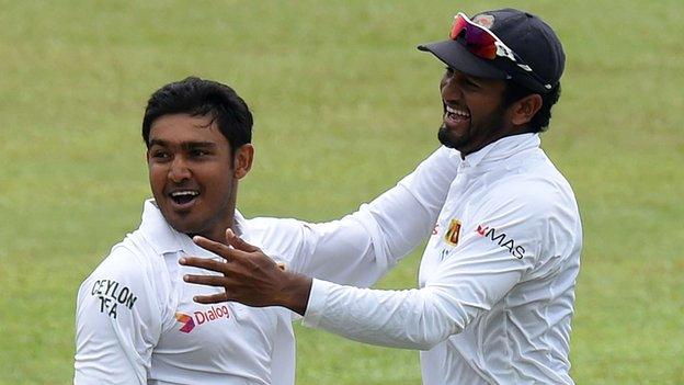 Sri Lanka's Milinda Siriwardana and Dimuth Karunaratne celebrate a wicket