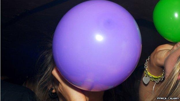 A women with a laughing gas balloon