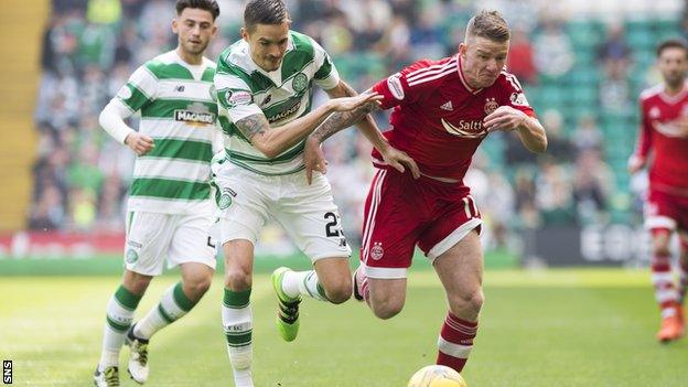 Celtic's Mikael Lustig and Aberdeen's Jonny Hayes race for the ball