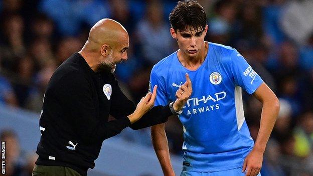 Pep Guardiola talks to Finley Burns during Manchester City's 6-1 win over Wycombe in September 2021