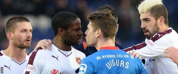 Hearts' Arnaud Djoum and Caley Thistle's Iain Vigurs clash