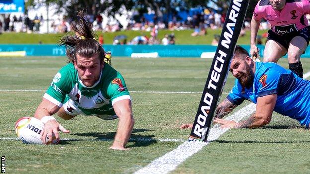 Ireland wing Liam Kay goes over for a try against Italy in Cairns on Sunday