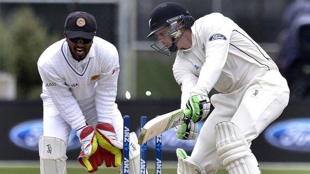 New Zealand's Martin Guptill is bowled, watched by Sri Lanka's Dinesh Chandimal