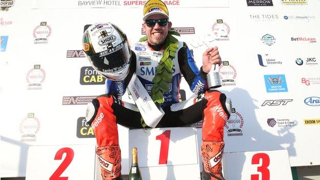 Peter Hickman sits on top of the podium after his Superstock success