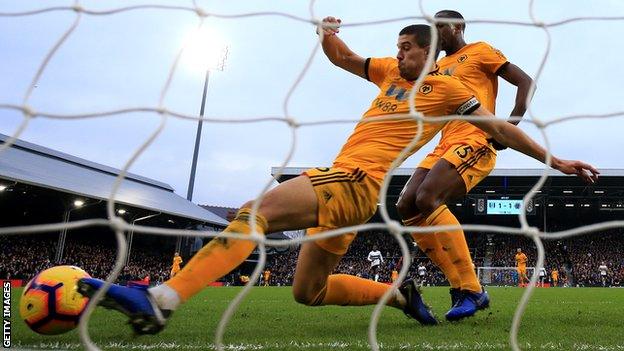 Wolves defender Conor Coady clears the ball off the line against Fulham