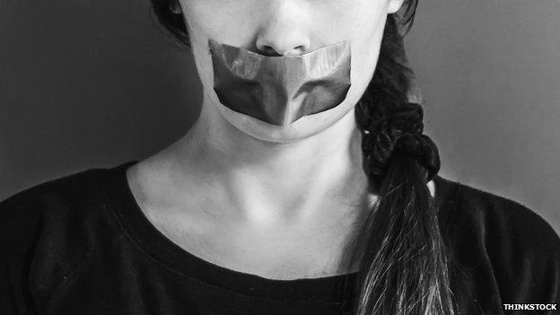 Woman with mouth taped over