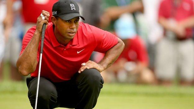 Tiger Woods lines up a putt