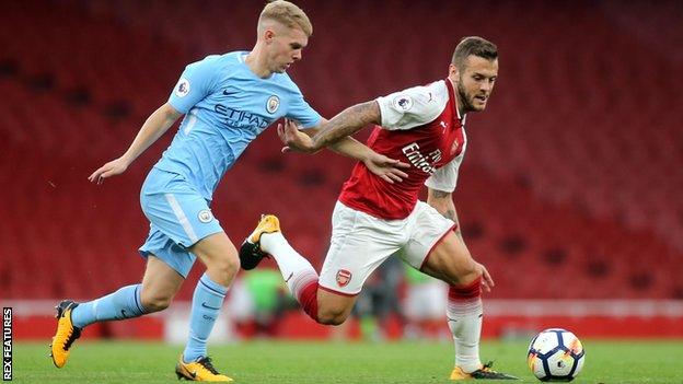 Jacob Davenport in action for Manchester City against Arsenal's Jack Wilshere