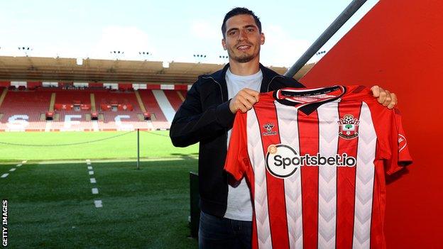 Romain Perraud holding up a Southampton shirt