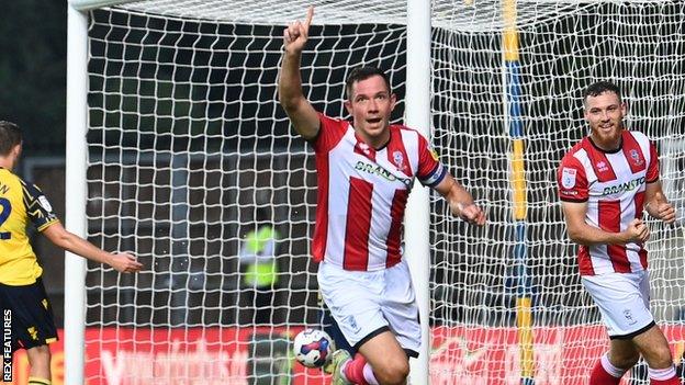 Lincoln City captain Tom Hopper scores the opener against Oxford United