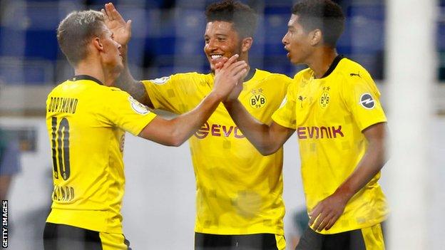 Jude Bellingham (right), celebrates with Jadon Sancho (centre)