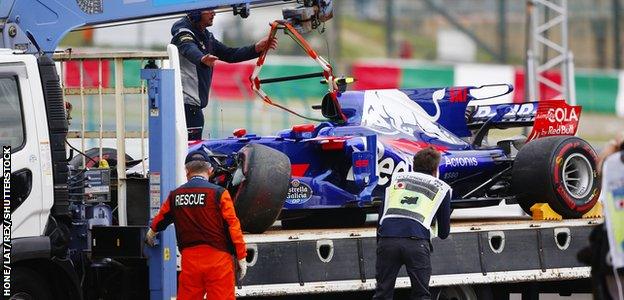 The car of Carlos Sainz Jr, Toro Rosso STR12 Renault, is returned to the pits after his crash.