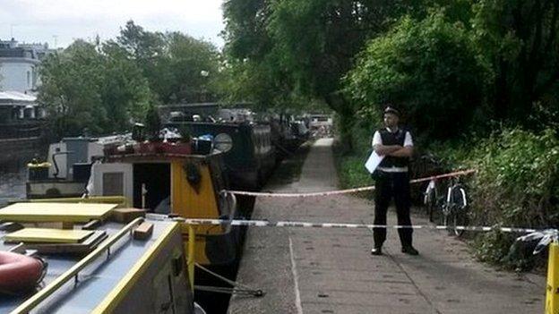 Policeman standing by the canal