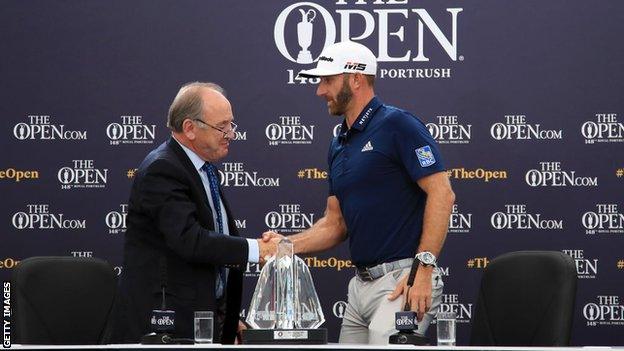 Official World Golf Ranking chairman Peter Dawson presents Dustin Johnson with the OWGR McCormack Award during a practice round prior to the 148th Open Championship.