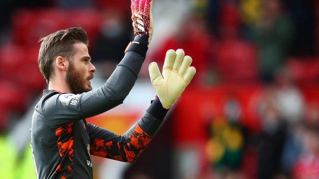 Manchester United goalkeeper David de Gea gestures to his teammates