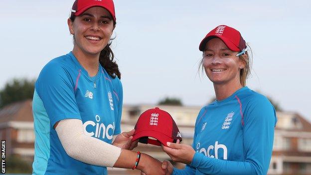 Maia Bouchier is presented with her England cap by Danni Wyatt on her debut against New Zealand