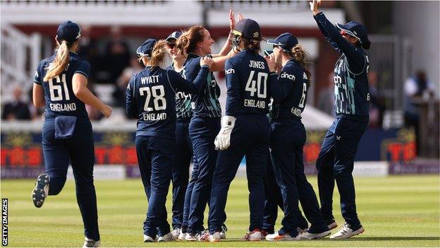 England players celebrate with Kate Cross after she took her third wicket against India at Lord's in September