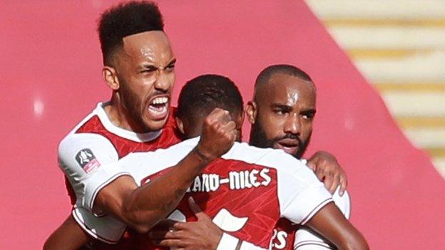 Arsenal's players celebrate a goal against Chelsea in the FA Cup final