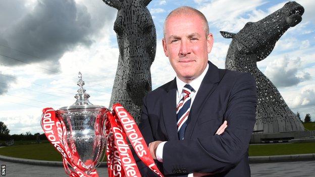 Mark Warburton poses with the Scottish Premiership trophy, with The Kelpies as a backdrop