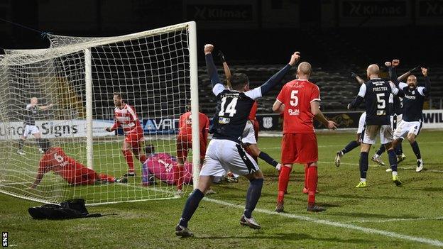 Jonathan Afolabi, hidden, scored in stoppage-time to take Dundee's tie with Bonnyrigg Rose to extra time