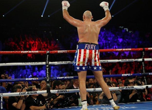 Tyson Fury turns to the crowd to celebrate his win over Tom Schwarz