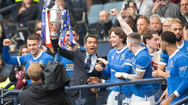 Rangers manager Giovanni van Bronckhorst lifts the Scottish Cup Trophy during the Scottish Cup Final match between Rangers and Hearts at Hampden Park