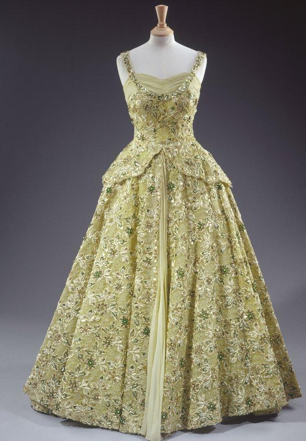 Sir Norman Hartnell designed this pale green crinoline evening gown made of silk chiffon and lace embroidered with sequins, pearls, beads and diamante. It was worn by Her Majesty The Queen in 1957 during her visit to the United States of America as a guest of President Eisenhower