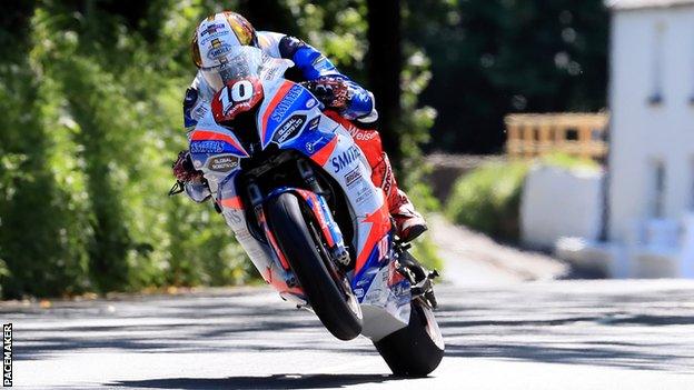 Peter Hickman lifts his front wheel on his way to victory in the Superstock race