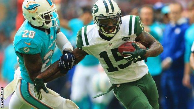 Brandon Marshall of the New York Jets holds off Reshad Jones