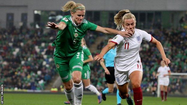 Julie Nelson attempts to get in a challenge on England's Lauren Hemp in Tuesday's World Cup qualifier at Windsor Park