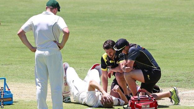 Adam Voges receives treatment after being struck on the head by a bouncer