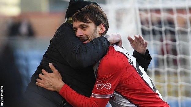 A Southampton fan hugs Manolo Gabbiadini