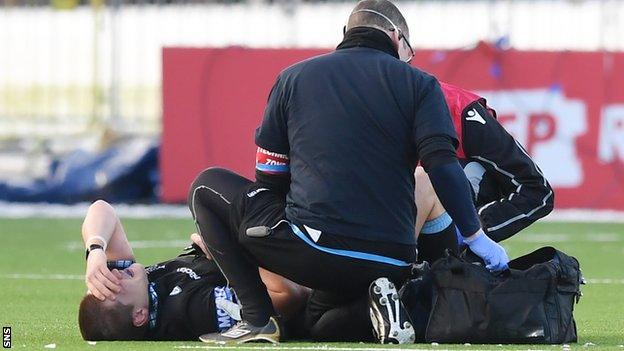 George Turner receives treatment after suffering a knee injury