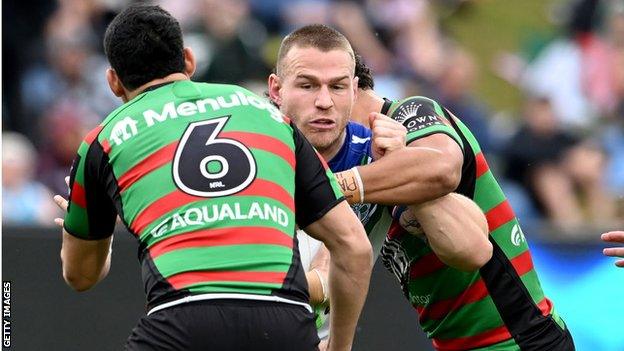 Euan Aitken of the Warriors takes on the defence during the round 21 NRL match between the South Sydney Rabbitohs and the New Zealand Warriors