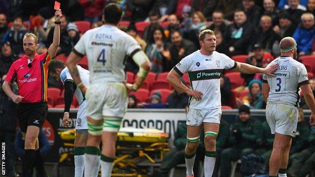 Ollie Hoskins (right) walks off after being shown a red card by referee Wayne Barnes (left)