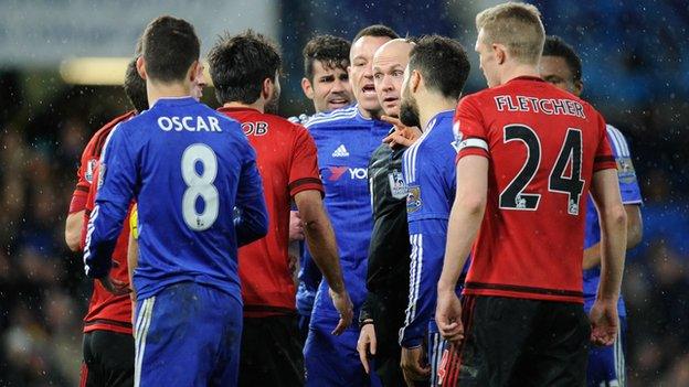 Chelsea and West brom players surround referee Anthony Taylor during the 2-2 draw between the two sides