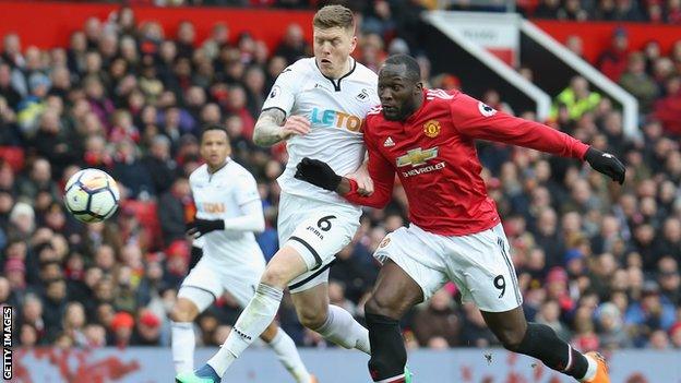 Swansea defender Alfie Mawson holds off Romelu Lukaku of Manchester United