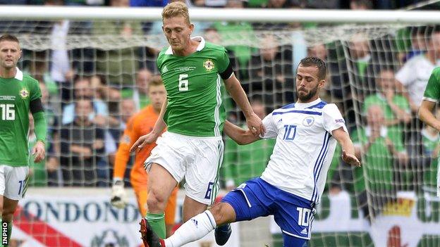 Northern Ireland's George Saville battles with Bosnia's Miralem Pjanic in Belfast last year