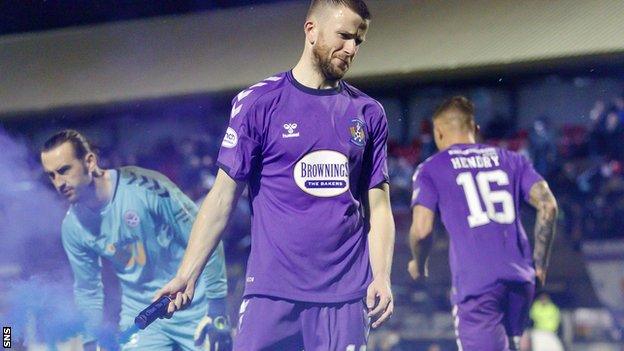 Ayr keeper Aidan McAdams, left, reacted after away fans threw flares on to the pitch