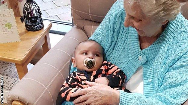 Jake Webster's son Leo held by a resident of Newfield Lodge Care Home