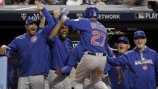 Addison Russell celebrates with the Cubs backroom staff