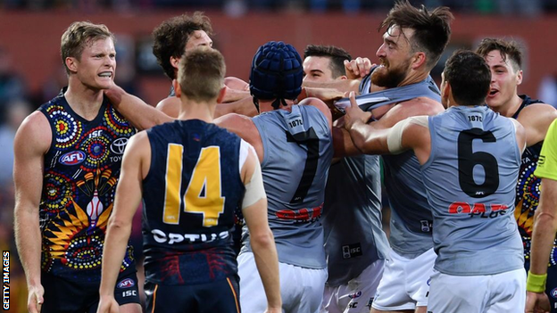 Port Adelaide and Adelaide players square up