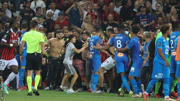 Fans invade pitch