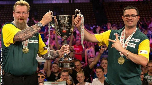 Simon Whitlock (L) and Damon Heta lift the trophy