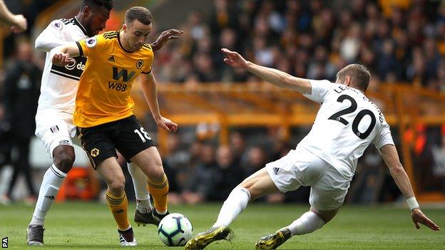 Wolves forward Diogo Jota nips round Fulham defender Maxime Le Marchand