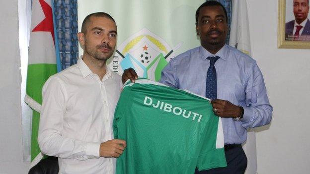 French coach Julien Mette (left) holds a Djibouti shirt with football federation president Souleiman Hassan Waberi