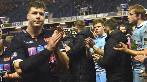 Grant Gilchrist applauds Edinburgh fans as Glasgow's Huw Jones and Jonny Gray look dejected