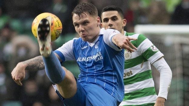 St Johnstone's Jason Kerr competes with Celtic's Tom Rogic (right)